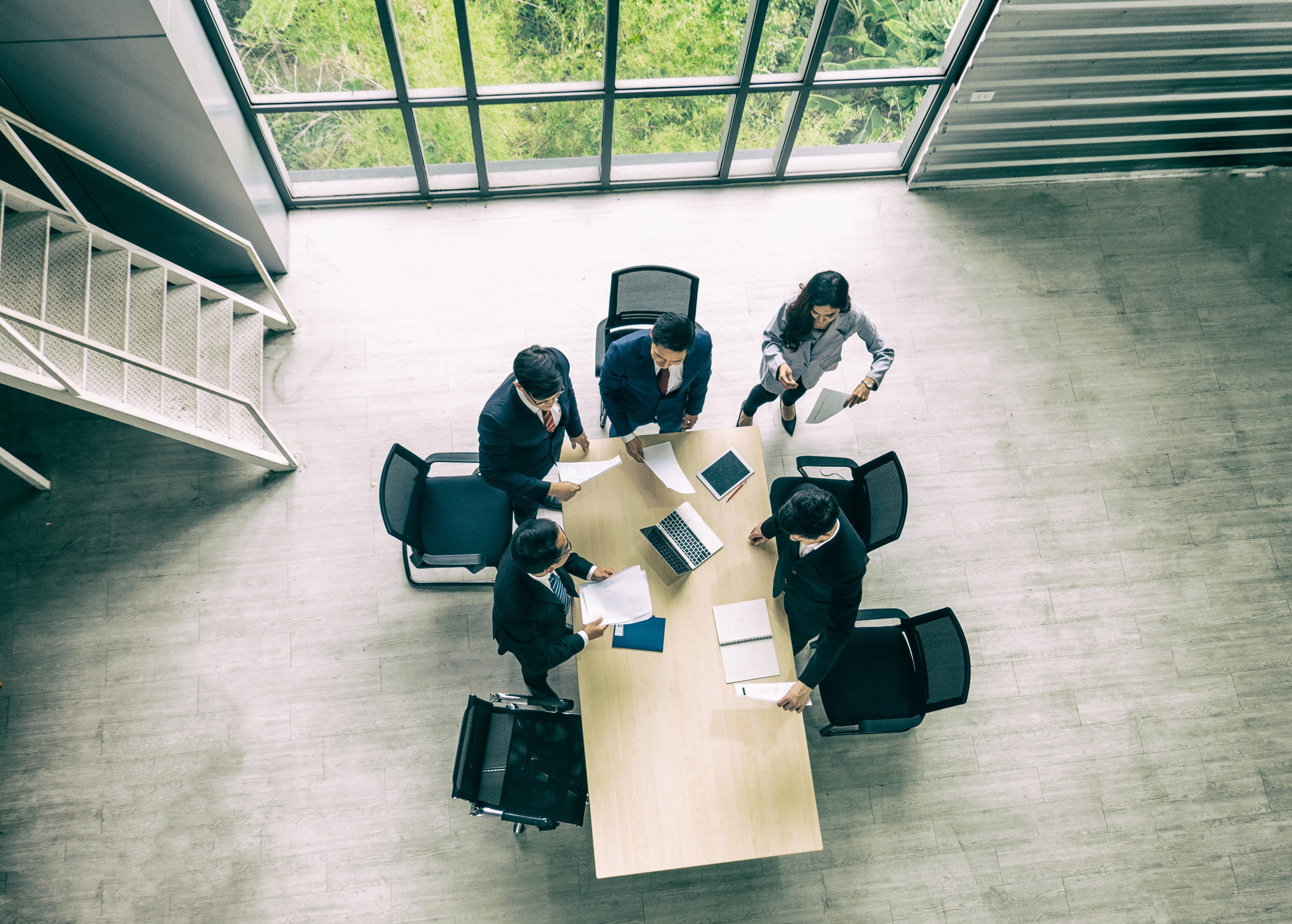 Top view on business people around meeting desk